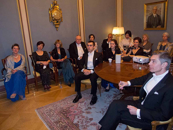 Spouses et al watching live video feed of the awarding ceremony