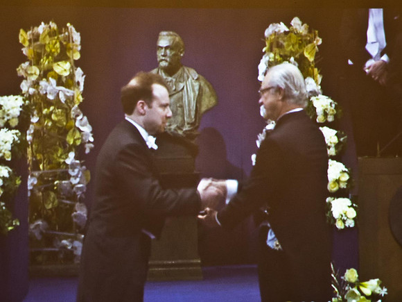 Adam receiving the Nobel Medal from the King of Sweden