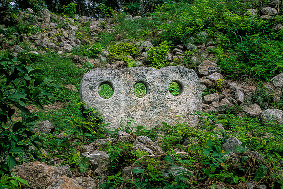 Uxmal - Stone with three holes in the Cementerio Group.