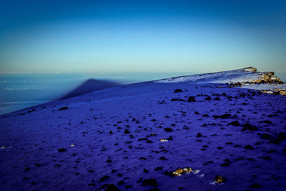 The Sunrise Shadow of Kilimanjaro Over the African Plains from the Summit